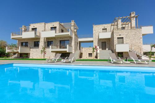 a villa with a swimming pool in front of a building at Azari Lifetime Memories in Paralion astros