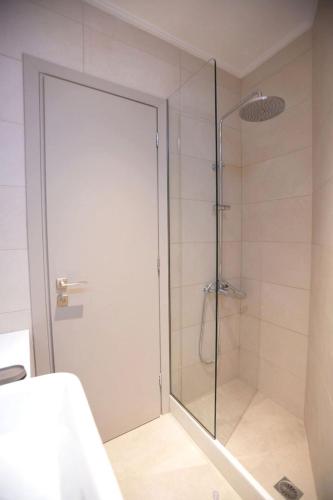a shower with a glass door in a bathroom at Azari Lifetime Memories in Paralion astros