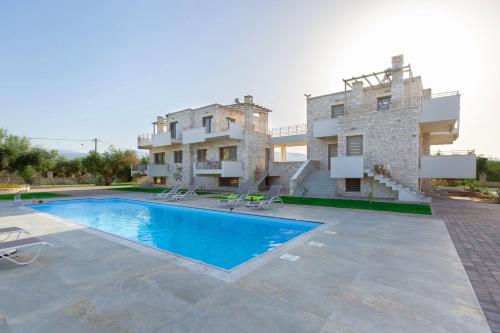 a villa with a swimming pool in front of a building at Azari Lifetime Memories in Paralion astros