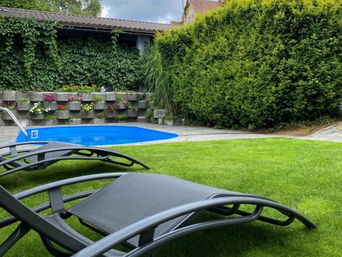 a yard with chairs and a swimming pool at Apart Hotel Jablonec in Jablonec nad Nisou