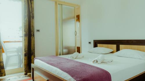 a bedroom with a bed with two towels on it at Guesthouse Shtino in Gjirokastër