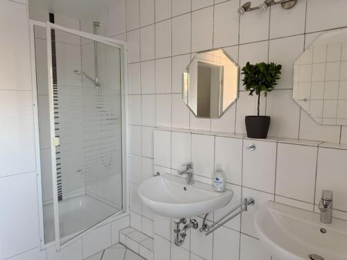 a white bathroom with a sink and a shower at House in Bergisch Gladbach in Bergisch Gladbach