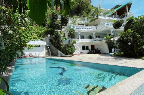 a swimming pool in front of a building at Dream Bay Resort powered by Cocotel in Sabang