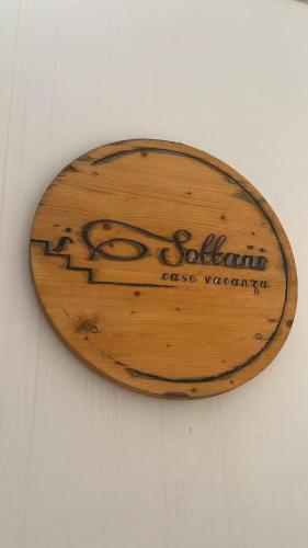 a wooden sign hanging on a wall at I Sottani in Monopoli