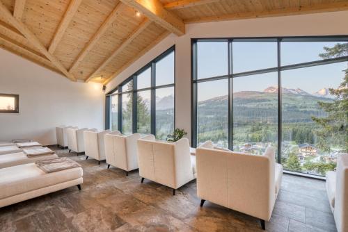a waiting room with a row of chairs and windows at Ursprung Panorama Hotel Königsleiten in Königsleiten