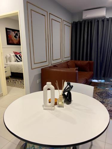 a white table in a living room with a couch at Sarona LoLa A103 Kappa in Gaborone