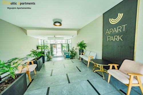 an empty lobby with chairs and a table at Baltic Apartments - Albus in Świnoujście