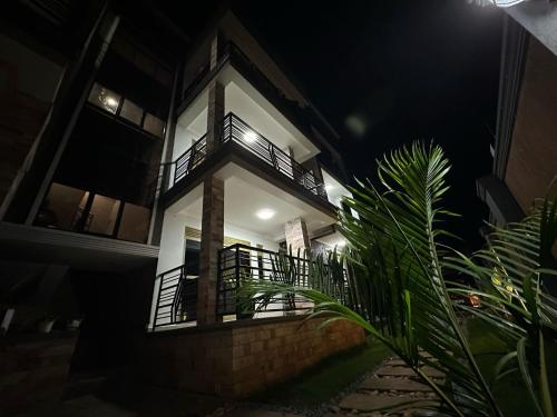 a building with a balcony at night at Luxe Loft in Kampala