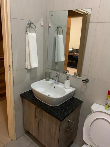a bathroom with a sink and a toilet at Comfort at home in Gaborone