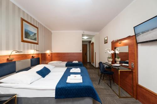 Postel nebo postele na pokoji v ubytování Hotel Rejs