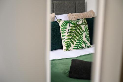 a bunk bed with green and white pillows on it at Stylish Interior Designed Home in Crewe