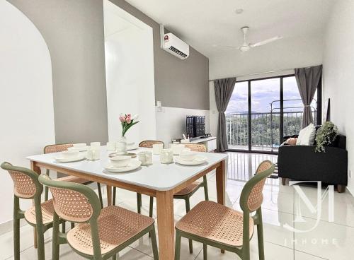 a dining room with a white table and chairs at C180 Trader Park 3BR Family Suite #20 in Cheras