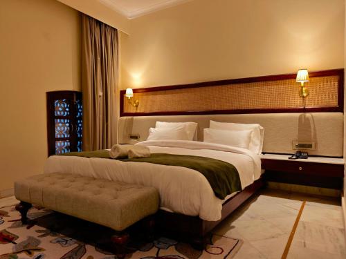 a bedroom with a large bed with a large headboard at Gauri Gangaa in Haridwār