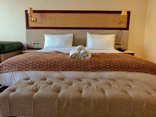 a bedroom with a bed with a pair of shoes on it at Gauri Gangaa in Haridwār