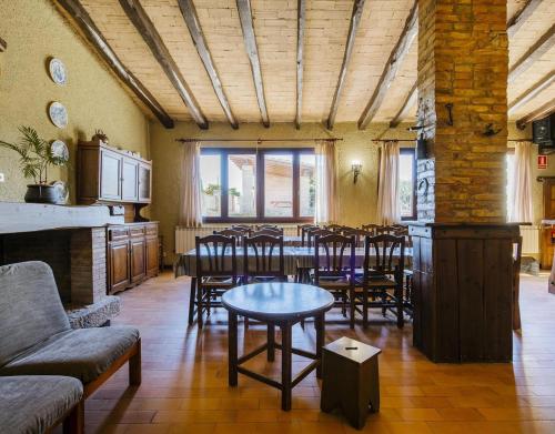 a dining room with a table and some chairs at Can Fonsu in Galliners