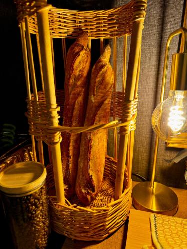 a basket of loaves of bread sitting on a table at Les Vieilles Digues in Beauvoir