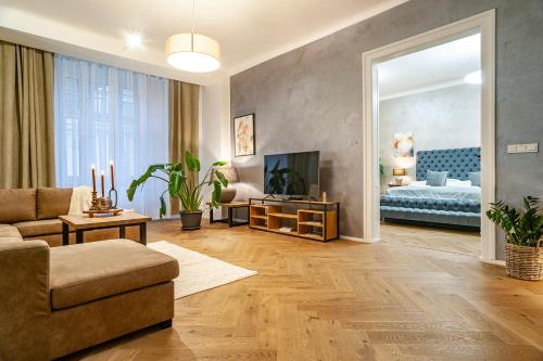 a living room with a couch and a television at Sting Old Town Ostrava in Ostrava