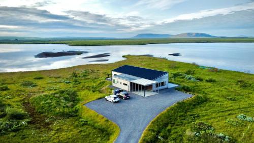an overhead view of a tiny house with a car parked at Austurey - Lakefront Villa in Laugarvatn
