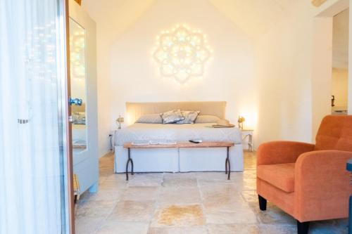 a bedroom with a bed with a table and a chair at Dimora Dei Semplici in Ostuni