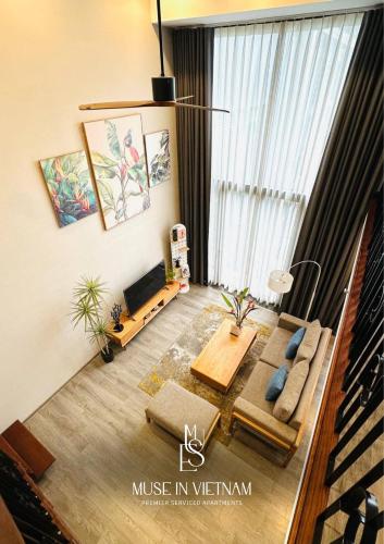 a living room with a couch and a table at Muse Hanoi PentStudio West Lake in Hanoi