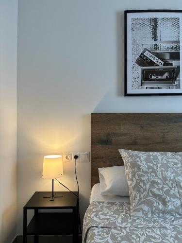 a bedroom with a bed and a lamp on a table at Apartamentos Vernia 5-19 in Xàtiva