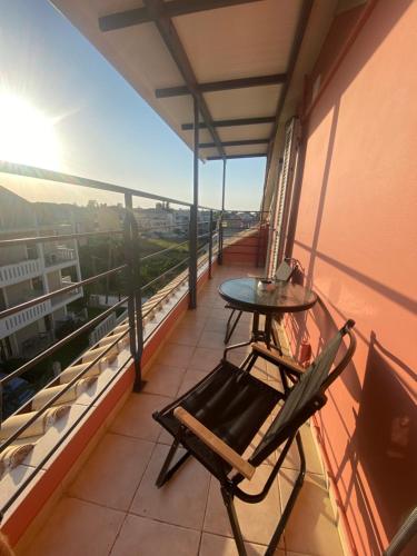 a balcony with a table and chair on a building at Lefkas Rooftop in Lefkada Town