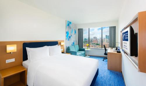 a hotel room with a bed and a tv at Holiday Inn Express Macau City Centre by IHG in Macau