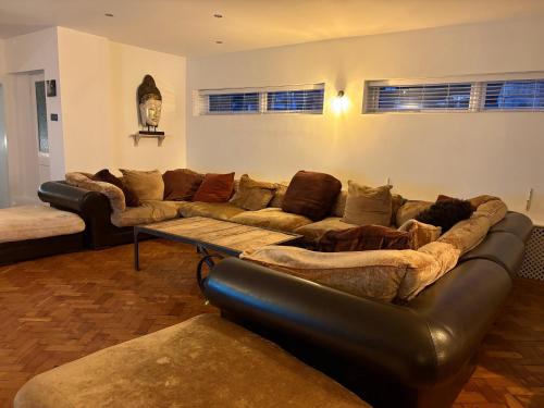 a living room with a couch and a table at Delmonte Lodge in Torquay