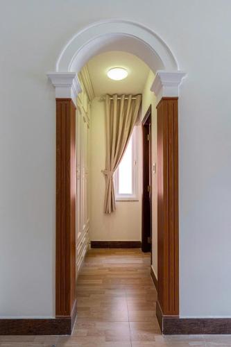 an empty hallway with a window and a corridorngthngthngthngthngthngthngth at Villa La Rose Blanc Thảo Điền in Ho Chi Minh City