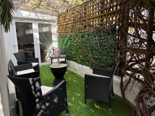 a patio with chairs and a table with grass at Delmonte Lodge in Torquay