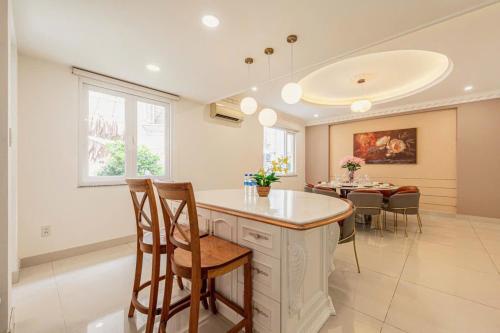 a kitchen and dining room with a table and chairs at Villa La Rose Blanc Thảo Điền in Ho Chi Minh City