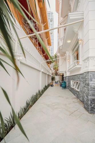 an empty hallway of a building with plants at Villa La Rose Blanc Thảo Điền in Ho Chi Minh City