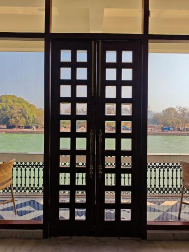 an open door with a view of the water at Gauri Gangaa in Haridwār