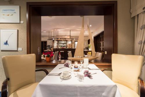 a dining room with a table and chairs at Hotel Boddenhus Garni in Zingst