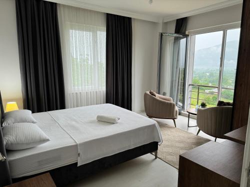 a hotel room with a bed and a large window at One Suit in Kartepe
