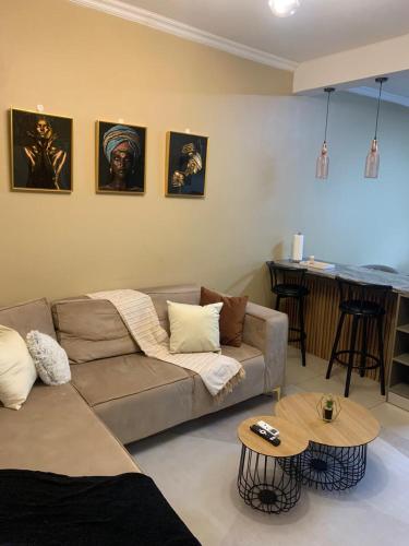 a living room with a couch and a table at Comfort at home in Gaborone