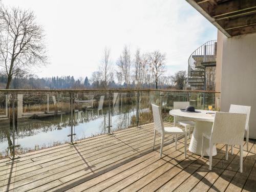 a deck with a table and chairs and a view of a river at The Skydeck HM50 in Cirencester