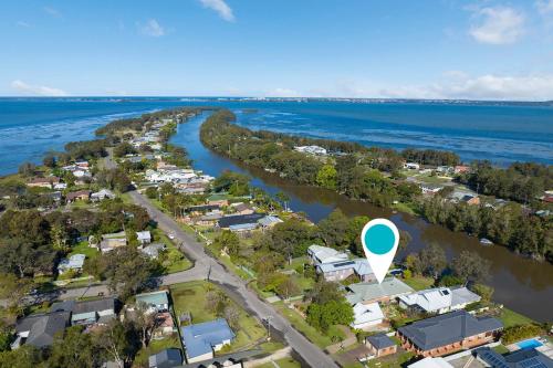 an aerial view of a town next to a river at Lakefront Serenity in Chittaway Point