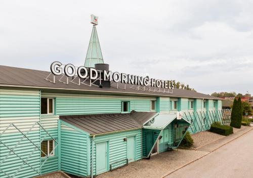 a blue building with a sign that reads good morning hotels at Good Morning Västerås in Västerås