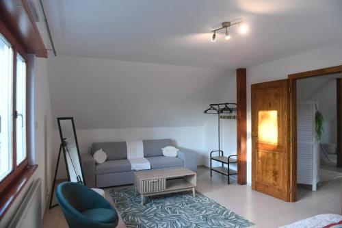 un salon avec un canapé et une table dans l'établissement Maison La Digue, à Plobsheim