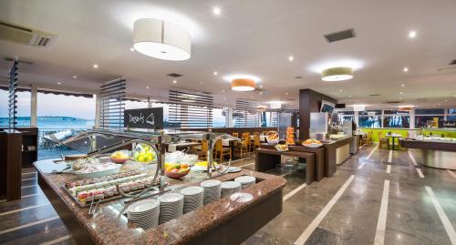 a restaurant with a buffet line with food at Hotel Zora in Primošten