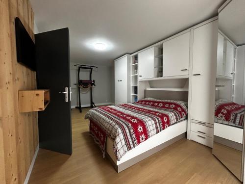 a small bedroom with a bed and a closet at Charmante maison à Évian avec terrasse et parking - FR-1-498-113 in Évian-les-Bains