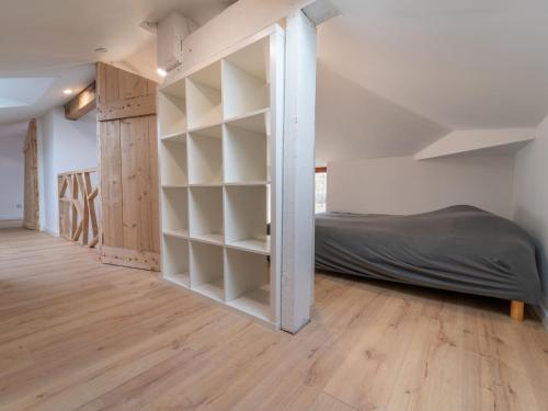 une chambre avec un lit et une étagère dans l'établissement Pontenx-les-Forges : Maison 8p avec Jardin et Climatisation - FR-1-50-164, à Pontenx-les-Forges