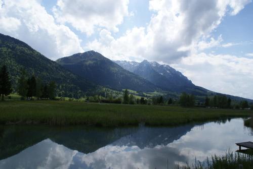 a view of a lake with mountains in the background at Mountain Inn Chalets & Apartments in Walchsee