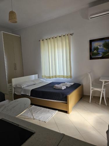 a bedroom with a bed and a window at Saranda Landscape in Nivicë