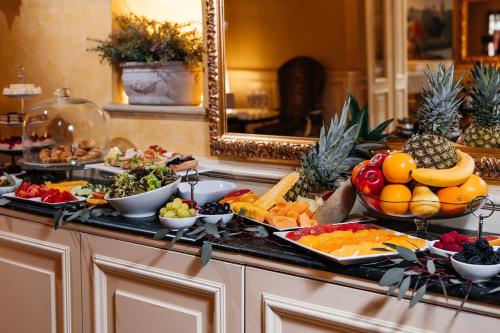 a buffet of fruit and vegetables on a counter at Alchymist Grand Hotel and Spa - Preferred Hotels & Resorts in Prague