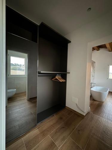 a bathroom with black walls and a tub and a sink at Il Morino in Centofinestre
