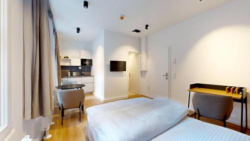 a bedroom with a bed and a table and chairs at Apartment 02 No 8A Boardinghouse Lüneburg in Lüneburg