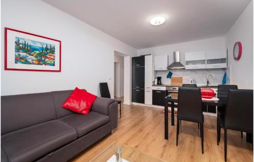 a living room with a couch and a table with chairs at Apartman Porec Center Sea in Poreč