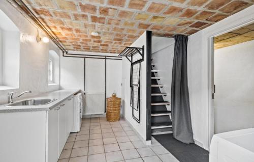 a kitchen with white cabinets and a brick ceiling at Gorgeous Home In Hadsund With Wifi in Hadsund